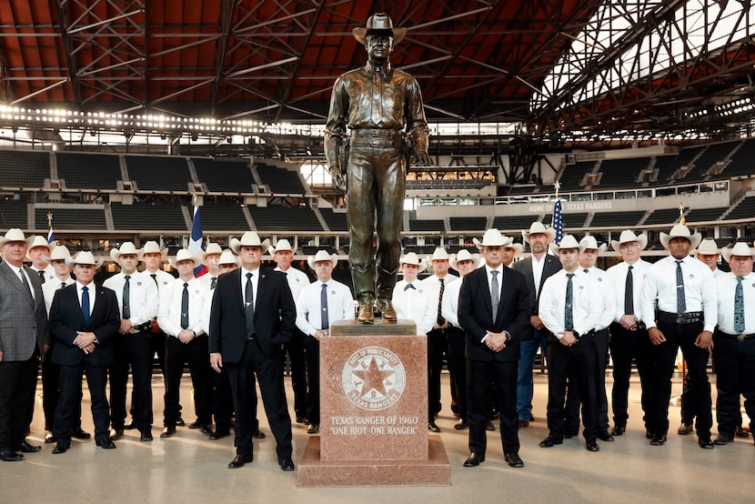Current and retired Texas Rangers posed Monday for a photo with "One Riot, One Ranger" on...