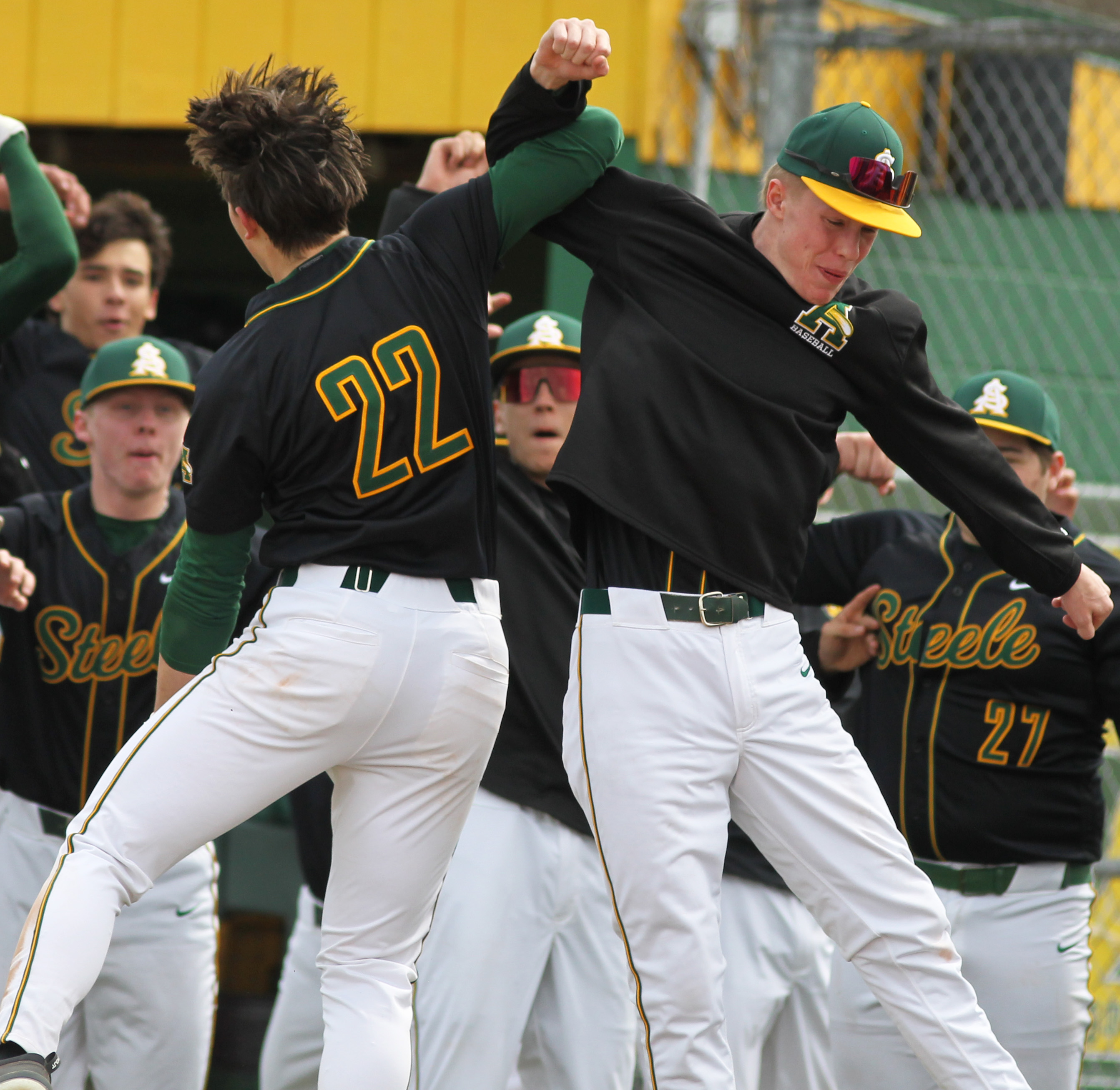 Cooper Bingham of Amherst (left) celebrates a home run against...