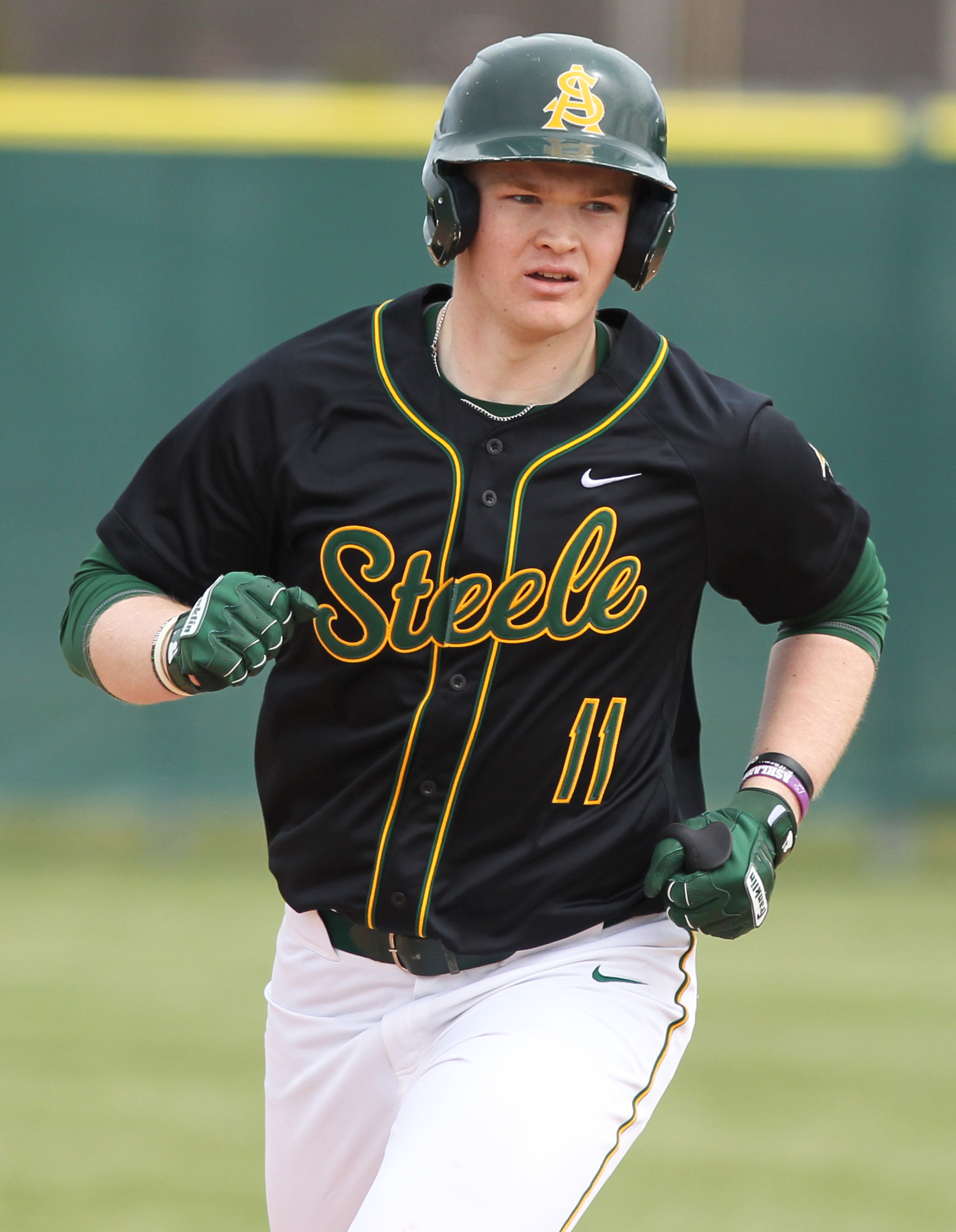 Landon Wolf of Amherst runs the bases after hitting a...