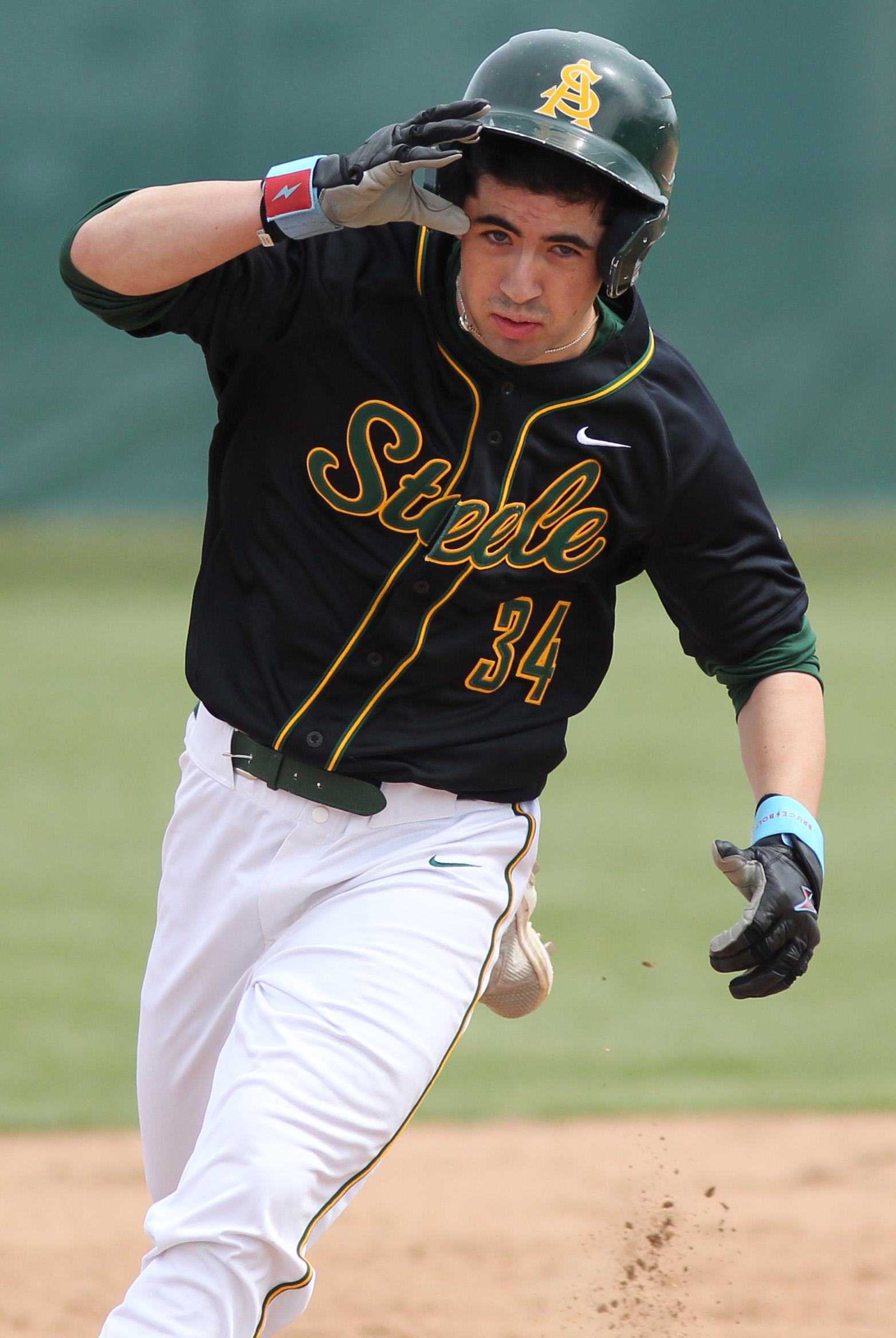 Zach Diedrick of Amherst advances to third following a base...