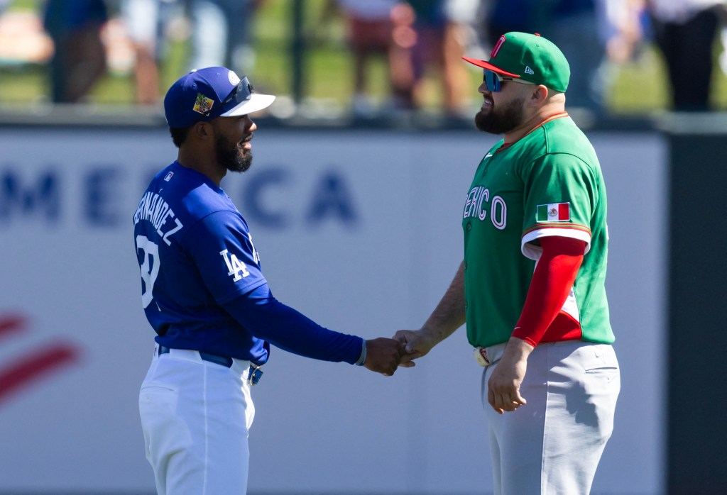 Teoscar Hernandez of the Los Angeles Dodgers shaking hands with Rowdy Tellez of Team Mexico.
