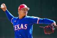 Texas Rangers pitcher Winston Santos throws live batting practice during a spring training...