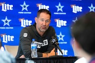 Dallas Cowboys head coach Brian Schottenheimer, left, responds to questions during a news...