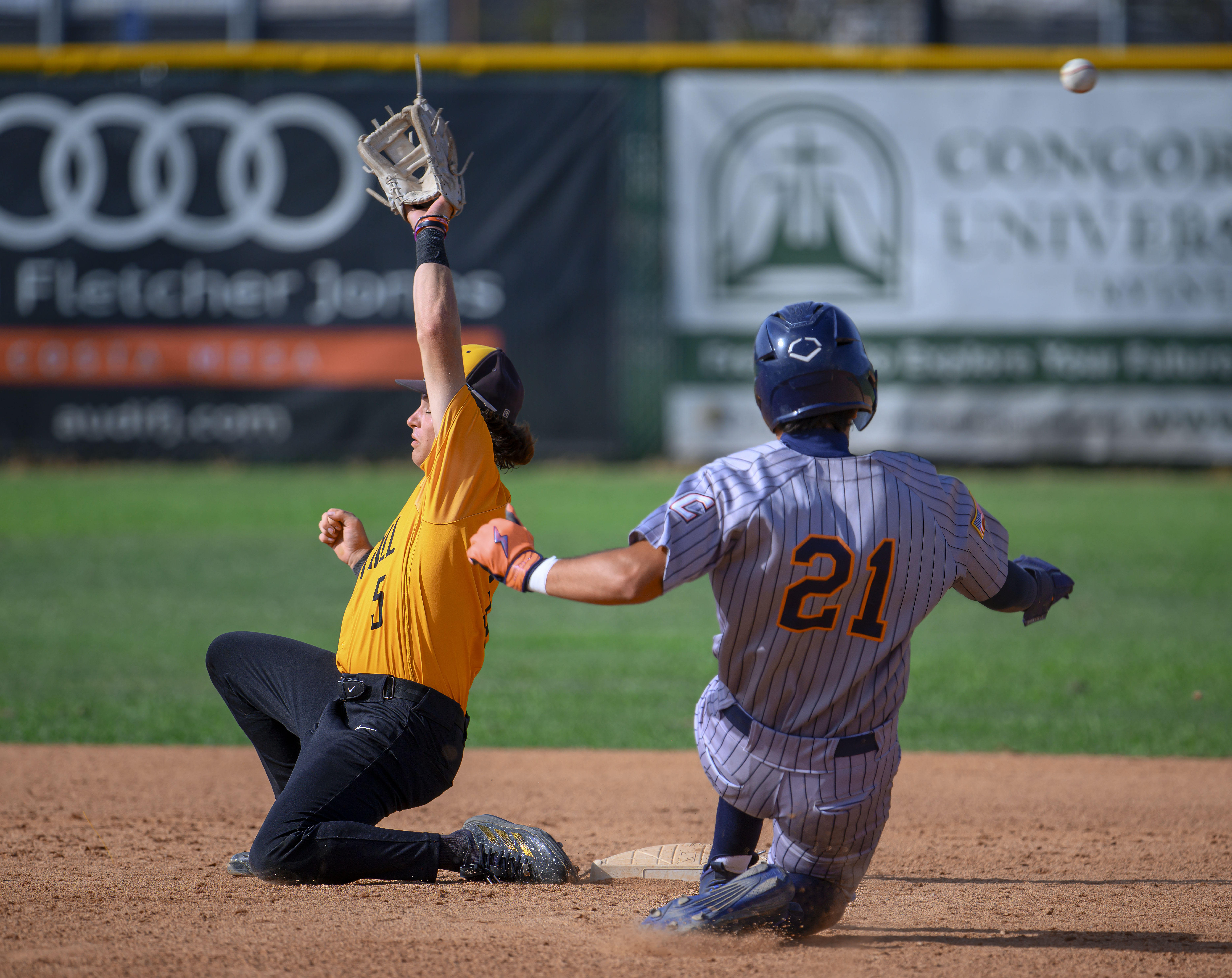 The throw from the catcher bounces over Foothill second baseman...