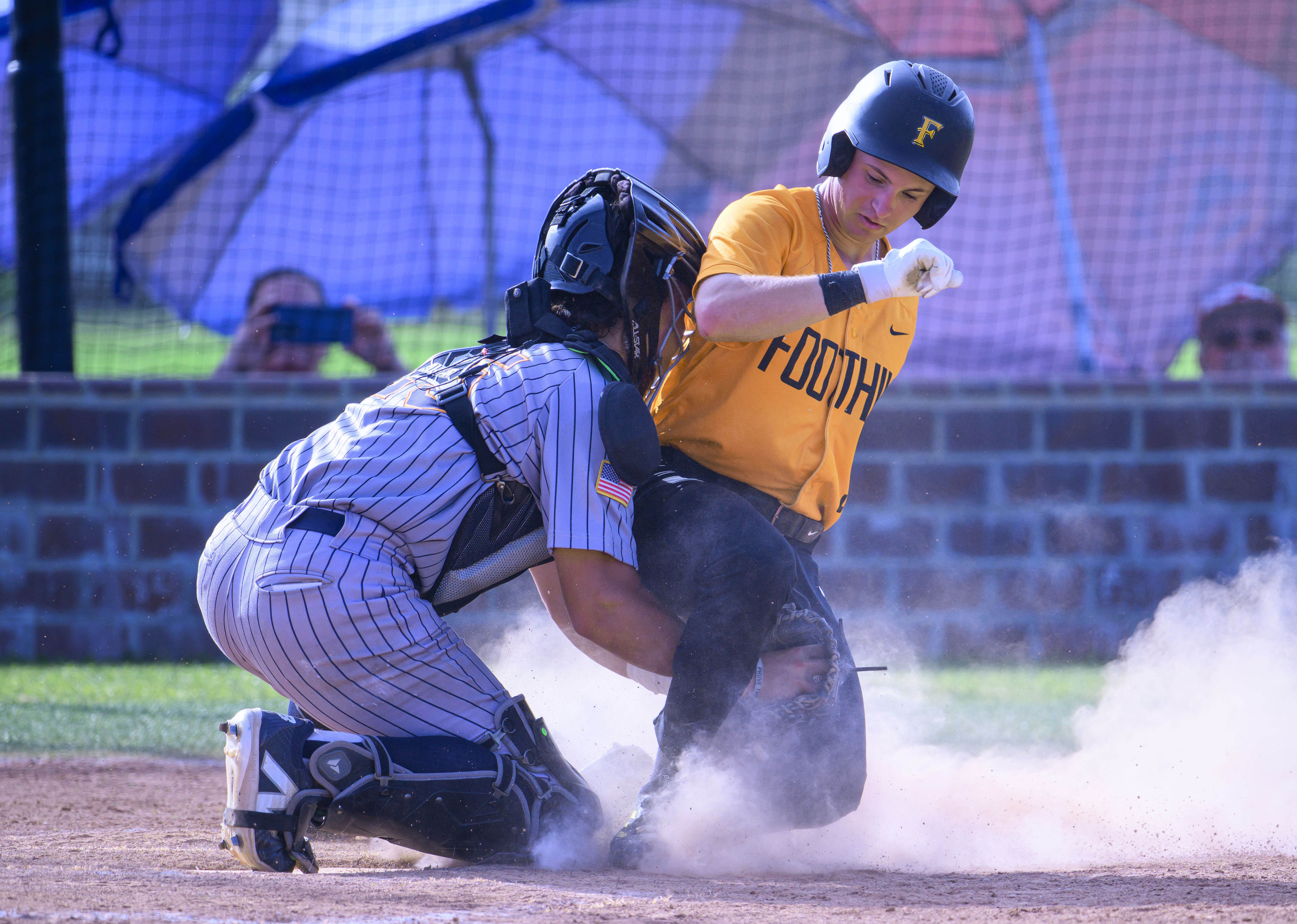 Foothillâs Patrick Petrossi, right is tagged out by Cypress catcher...