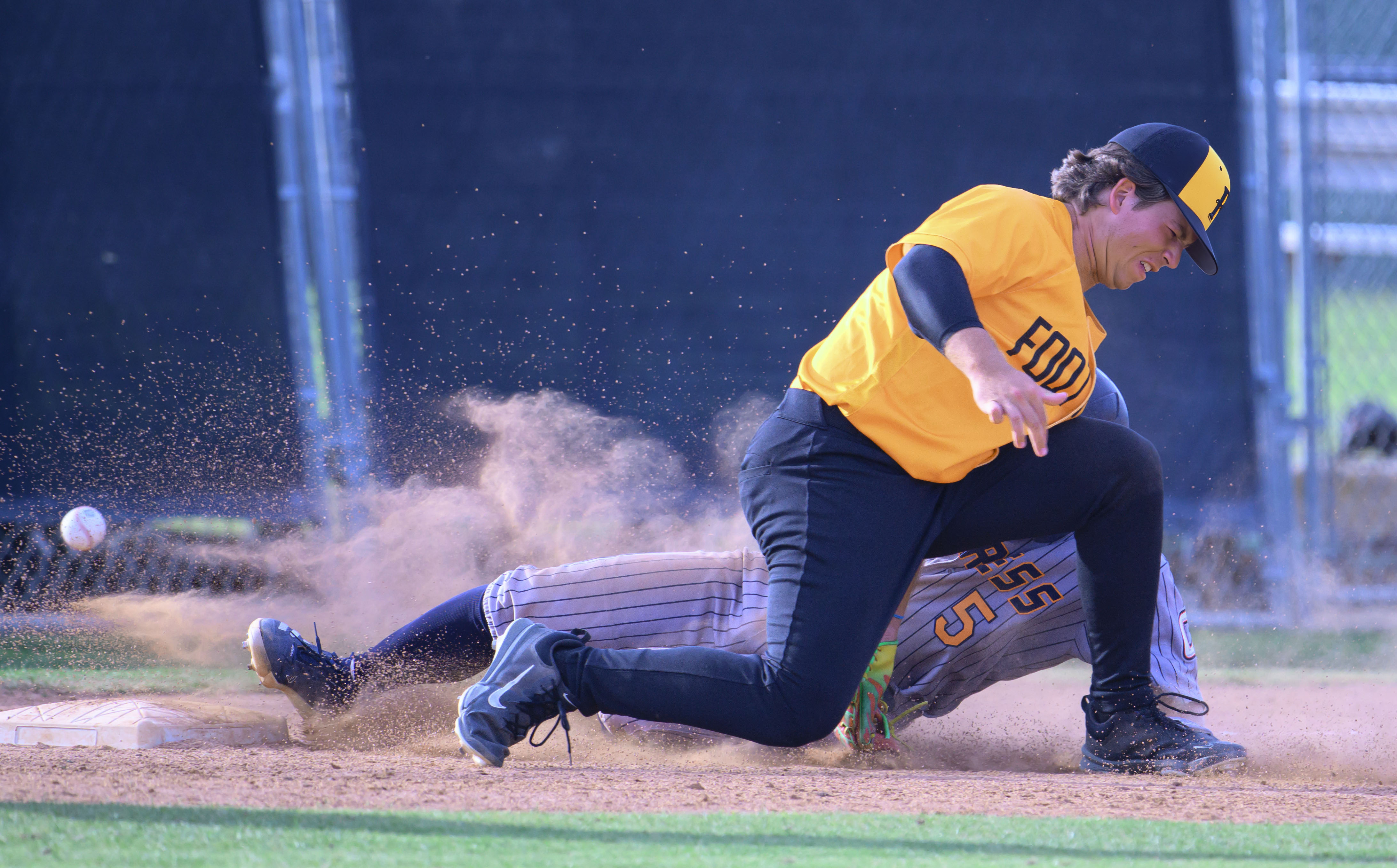 Cypress’ Jake de Laquil is safe at third as the...