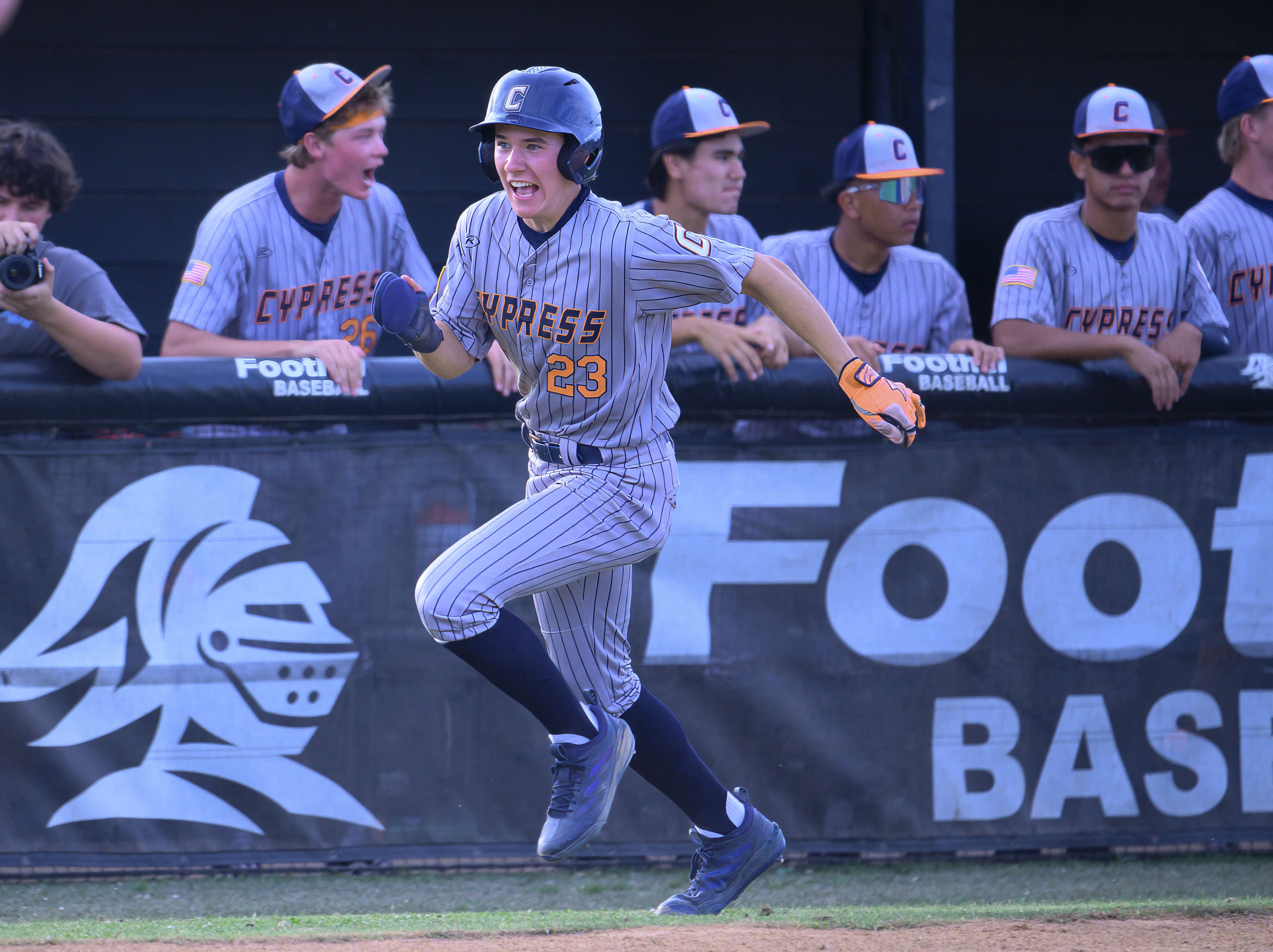 Cypress’ Gary Hennessy rounds third to score a run in...
