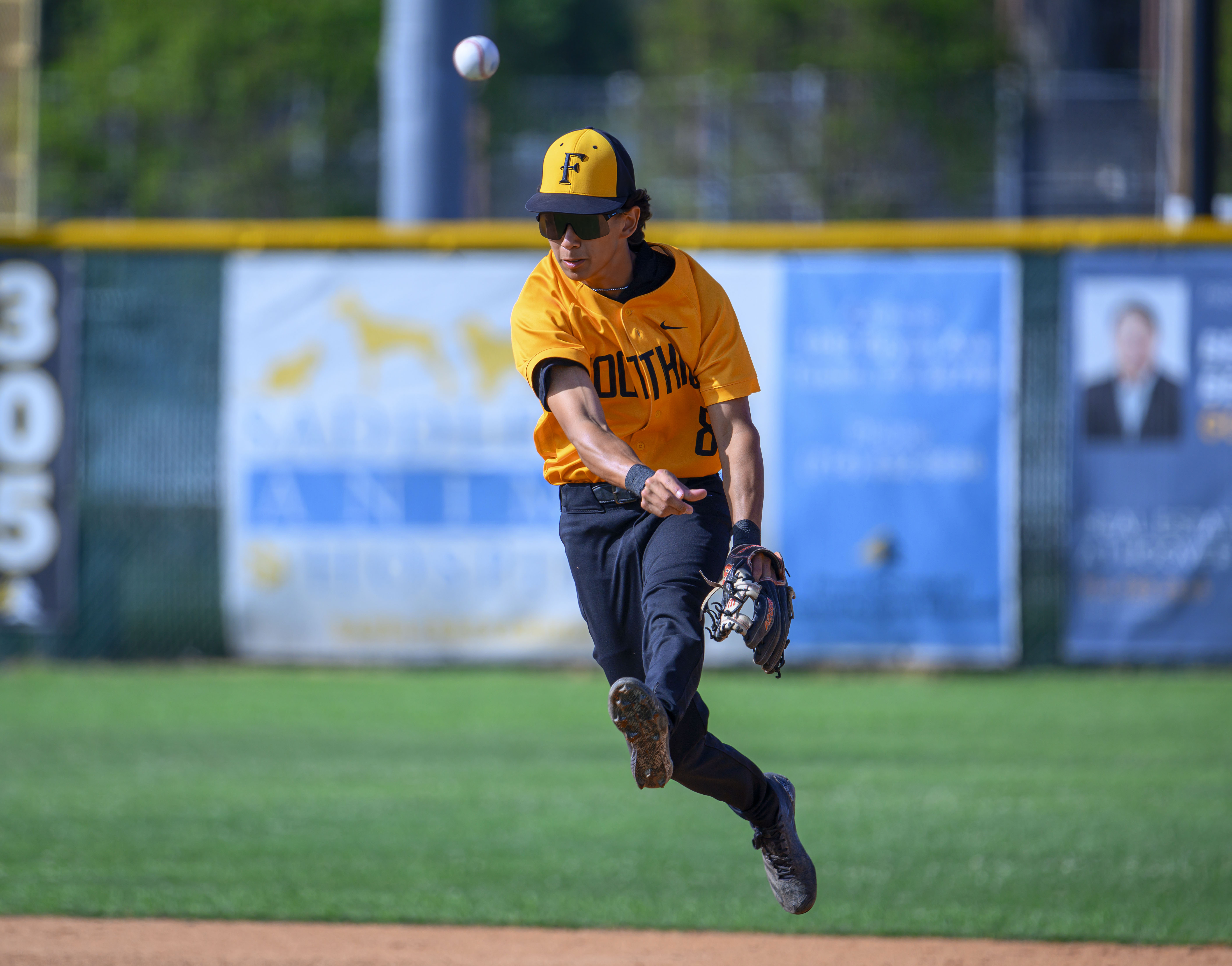 Foothill shortstop Jason Gugino fires the ball to first to...