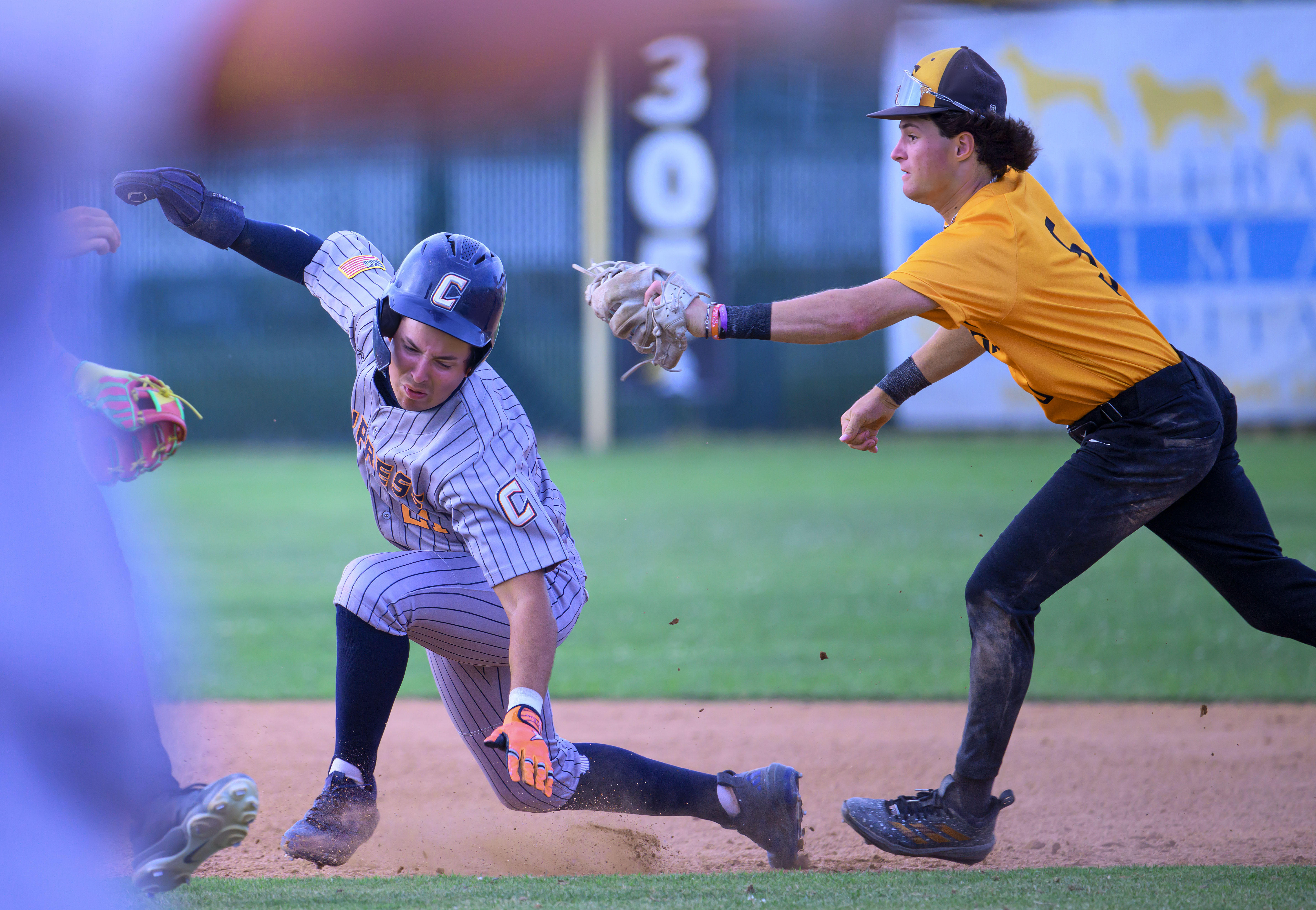Cypress’ Tyler Vladic, left, is tagged out by Foothill second...