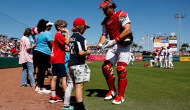 Philadelphia Phillies catcher J.T. Realmuto greets Little Leaguers before the game.