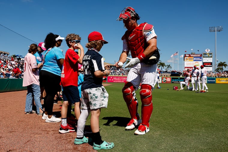 Philadelphia Phillies catcher J.T. Realmuto greets Little Leaguers before the game.