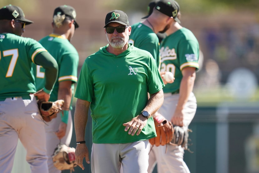 Athletics manager Mark Kotsay walks back to the team dugout after replacing a pitcher during...