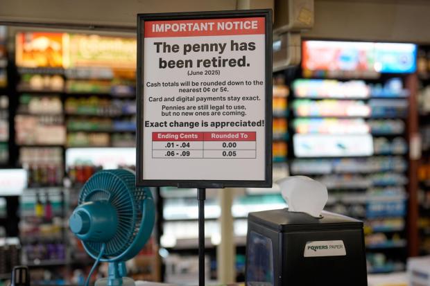 FILE - A sign in a Kwik Trip store shows the store will no longer be using pennies to give change, on Oct. 23, 2025, in Yorkville, Wis. (AP Photo/Morry Gash, File)