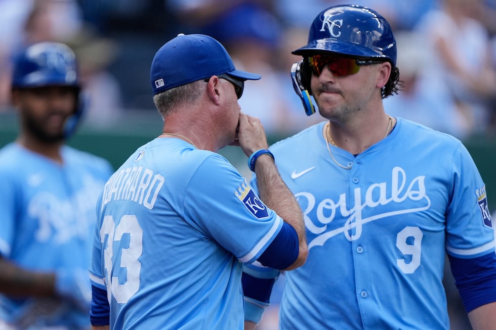 Kansas City Royals manager Matt Quatraro (33) talks to Vinnie Pasquantino (9) during the...