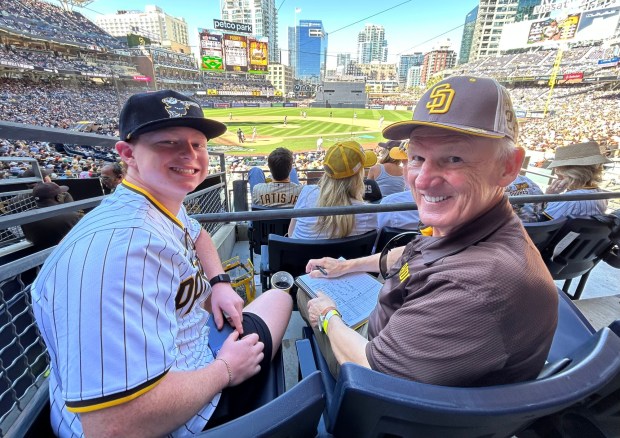 Ron Roberts and grandson Sullivan Fischbein were in their seats until the final out at Petco Park. (Kirk Kenney / San Diego Union-Tribune)