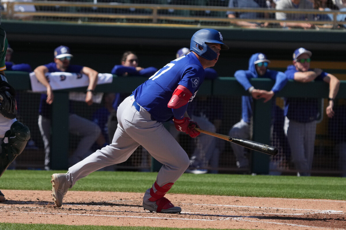 Los Angeles Dodgers left fielder Ryan Ward (67) hits an RBI double against the Athletics in the second inning at Hohokam Stadium.