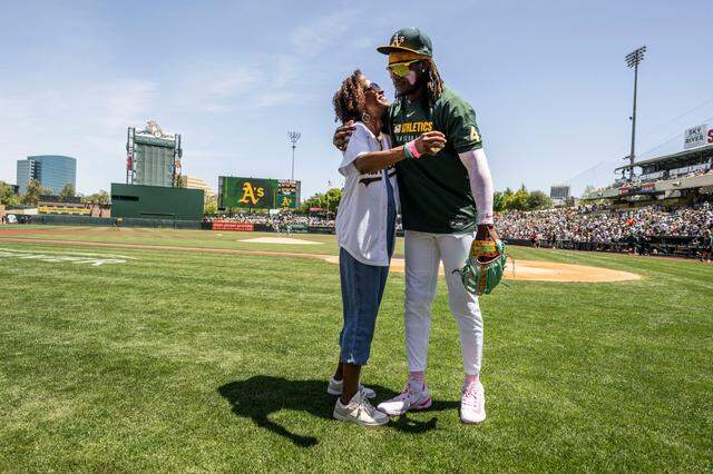 Lisa Butler hugs her son, Athletics outfielder Lawrence Butler, after a ceremonial first pitch before their game against the New York Yankees at Sutter Health Park on Mother’s Day, April 11, 2025.