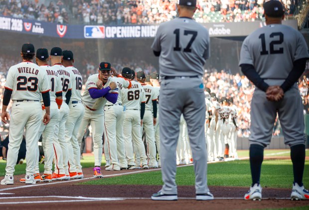 The San Francisco Giants and the New York Yankees stand before the national anthem during Opening Night at Oracle Park in San Francisco, Calif., on Wednesday, March 25, 2026. (Shae Hammond/Bay Area News Group)
