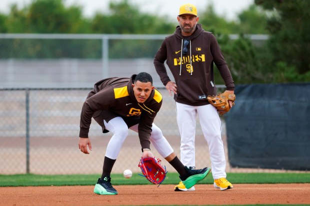 San Diego Padres infield coach Nick Punto watches Manny Machado #13 work through drills during spring training workouts at the Peoria Sports Complex on Friday, Feb. 13, 2026 in Peoria, Ariz.. (Meg McLaughlin / The San Diego Union-Tribune)