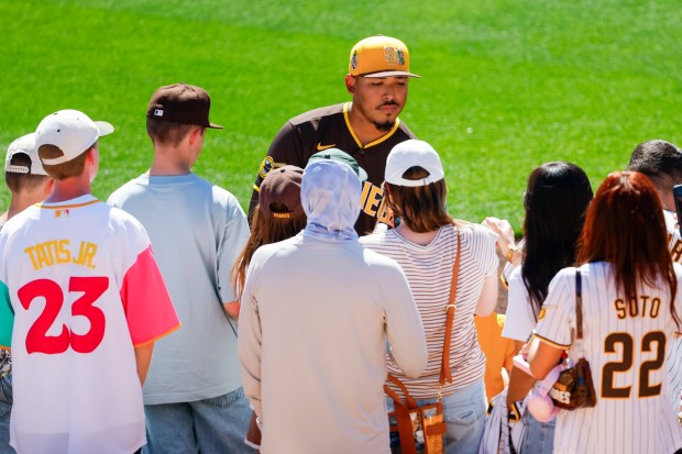 Jeremiah Estrada #56 of the San Diego Padres signs autographs for fans before their spring training game against the White Sox at Camelback Ranch on Tuesday, March 3, 2026 in Phoenix, Ariz. (Meg McLaughlin / The San Diego Union-Tribune)