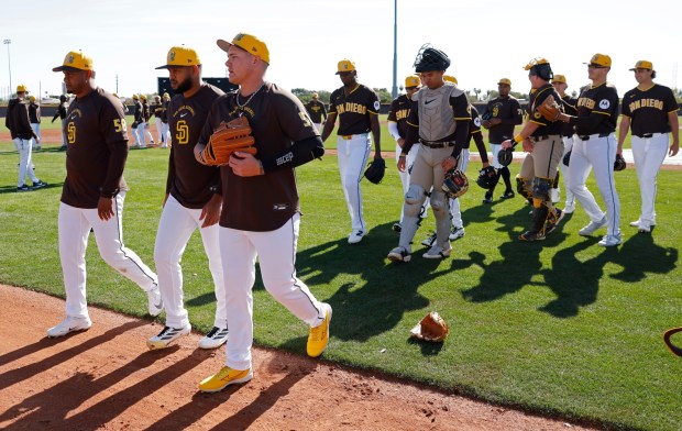 Adrian Morejon, center, walks with other pitchers during a Feb. 19 spring training practice in Peoria, Ariz. (K.C. Alfred / The San Diego Union-Tribune)