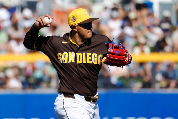Peoria, AZ - February 22: Manny Machado #13 of the San Diego Padres throws out James Tibbs III #98 of the Los Angeles Dodgers during a spring training game on February 22, 2026 in Peoria, AZ. (K.C. Alfred / The San Diego Union-Tribune)