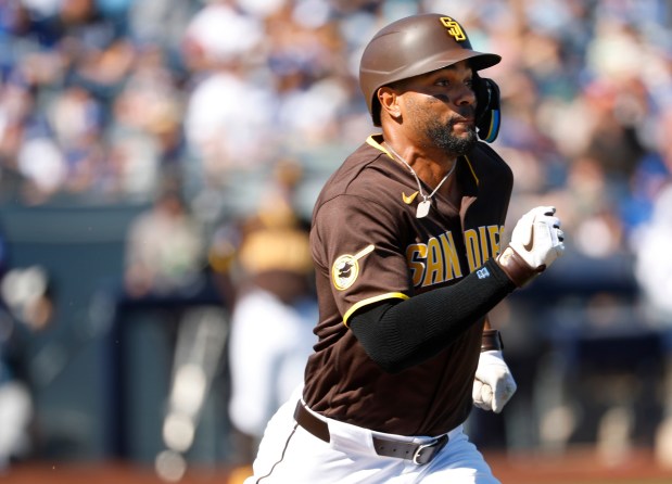 The Padres' Xander Bogaerts runs to first base during a spring training game against the Dodgers on February 22, 2026. (K.C. Alfred / The San Diego Union-Tribune)