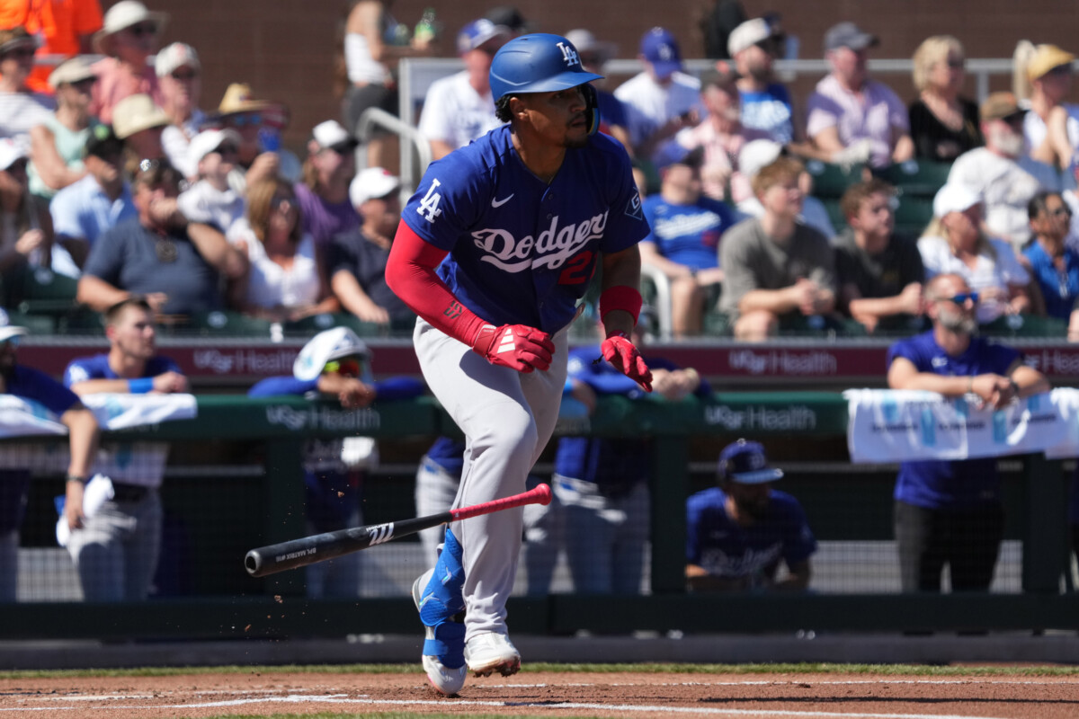 Los Angeles Dodgers second baseman Santiago Espinal hits the ball into play against the San Francisco Giants in the first inning at Scottsdale Stadium.