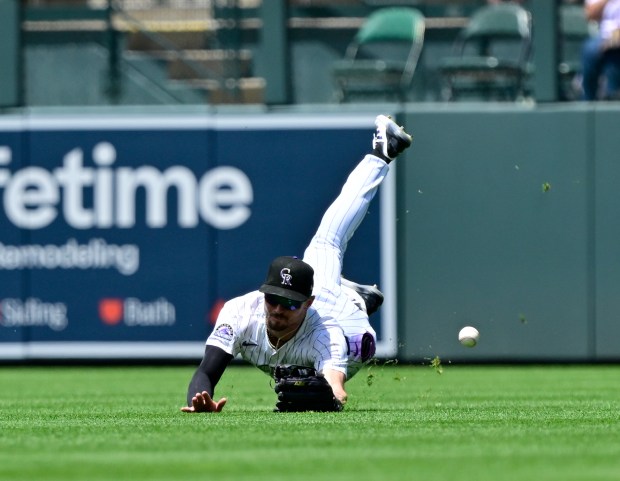 Colorado Rockies center fielder Brenton Doyle (9) can't get ahold of the ball on a single hit by San Francisco Giants center fielder Jung Hoo Lee (51) in the 2nd inning at Coors Field in Denver, on Thursday, June 12, 2025. (Photo by Andy Cross/The Denver Post)