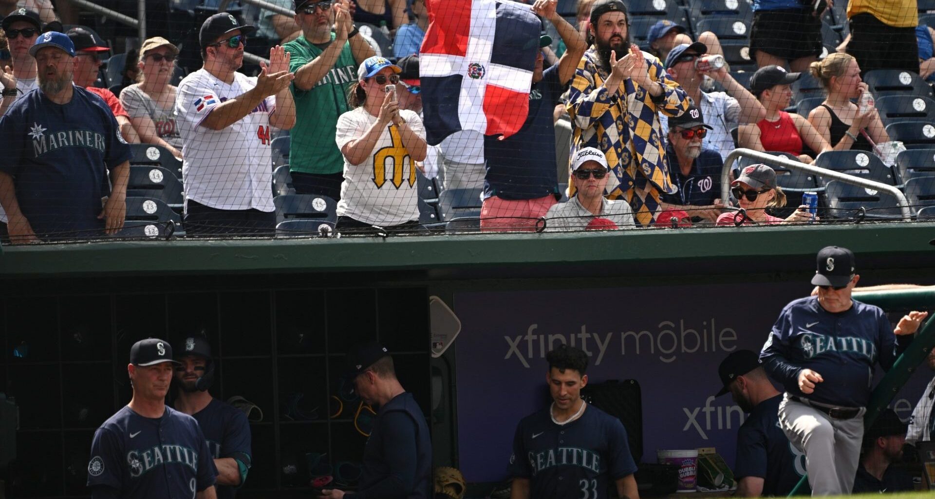 May 26, 2024; Washington, District of Columbia, USA; Seattle Mariners fans hold up a flag of the Dominican Republic after center fielder Julio Rodriguez (44) gets a bae hit (not pictured) during the ninth inning at Nationals Park. Mandatory Credit: Rafael Suanes-USA TODAY Sports