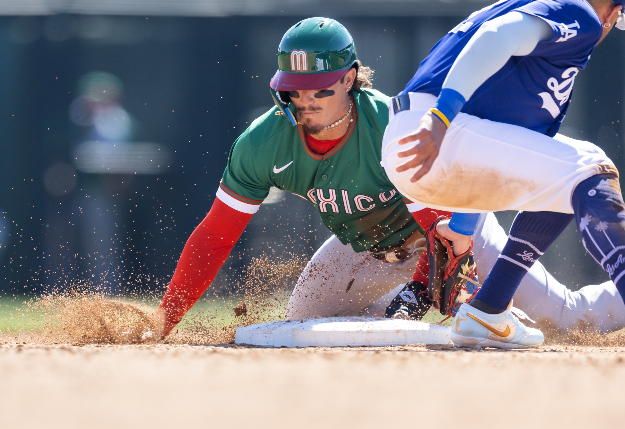 Mar 4, 2026; Glendale, AZ, USA; Team Mexico outfielder Jarren Duran slides into second with a stolen base against the Los Angeles Dodgers during a spring training game at Camelback Ranch. Mandatory Credit: Mark J. Rebilas-Imagn Images