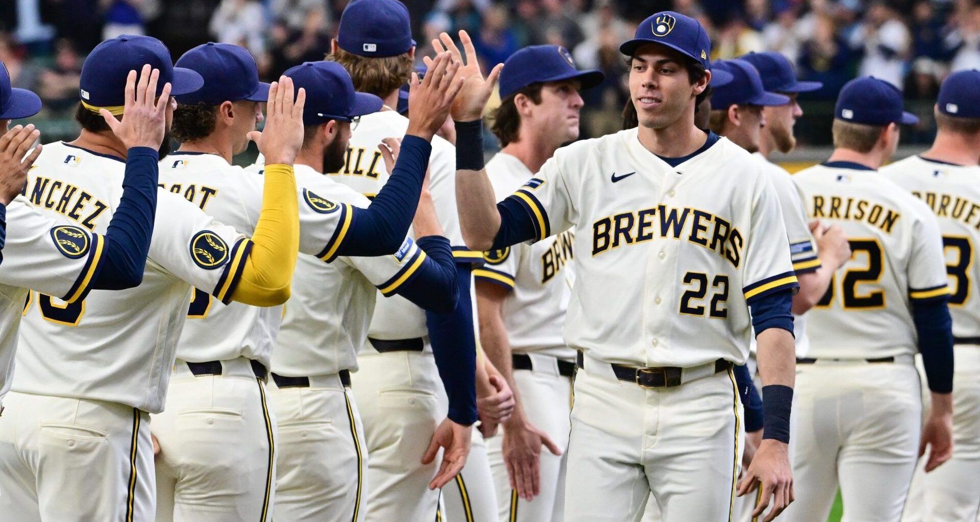 Mar 26, 2026; Milwaukee, Wisconsin, USA; Milwaukee Brewers designated hitter Christian Yelich (22) greets teammates during team introduction before Opening Day against the Chicago White Sox at American Family Field. Mandatory Credit: Benny Sieu-Imagn Images