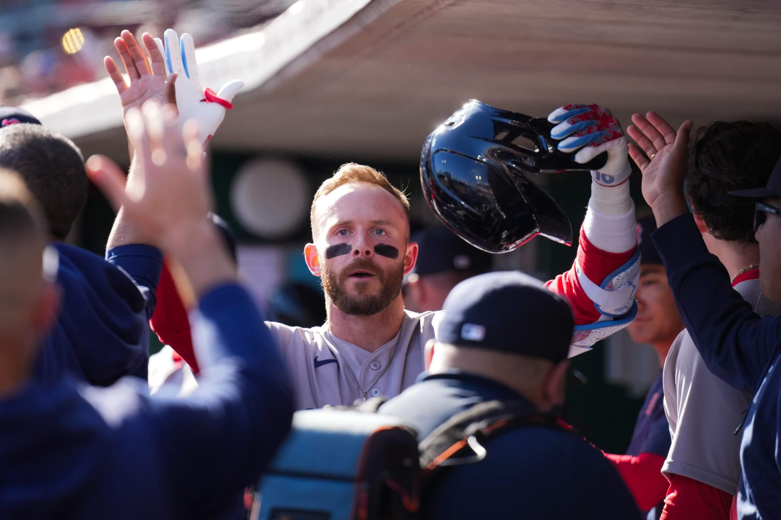 Trevor Story high-fives teammates after hitting a home run.