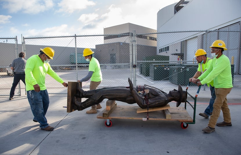 A Phoenix 1 Restoration & Construction crew wheeled out the "One Riot, One Ranger" statue...