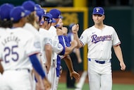 Texas Rangers first baseman Nathaniel Lowe (30) greets teammates before the season opener at...