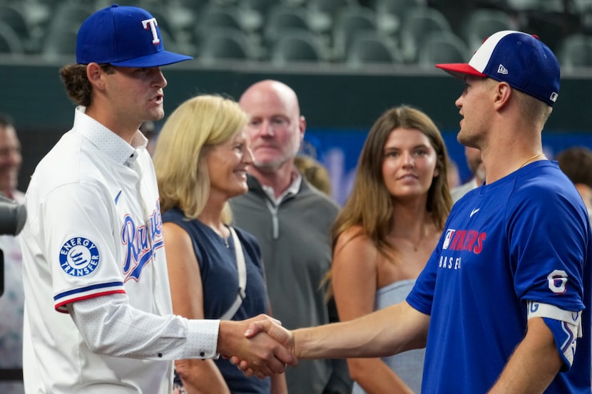 Texas Rangers second round draft pick AJ Russell shakes hands with third baseman Josh Jung...