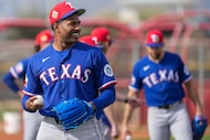 Texas Rangers pitcher Kumar Rocker throws on a back field during a spring training workout...