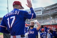 Texas Rangers pitcher Nathan Eovaldi gets a hand from infielder Ezequiel Duran as he comes...
