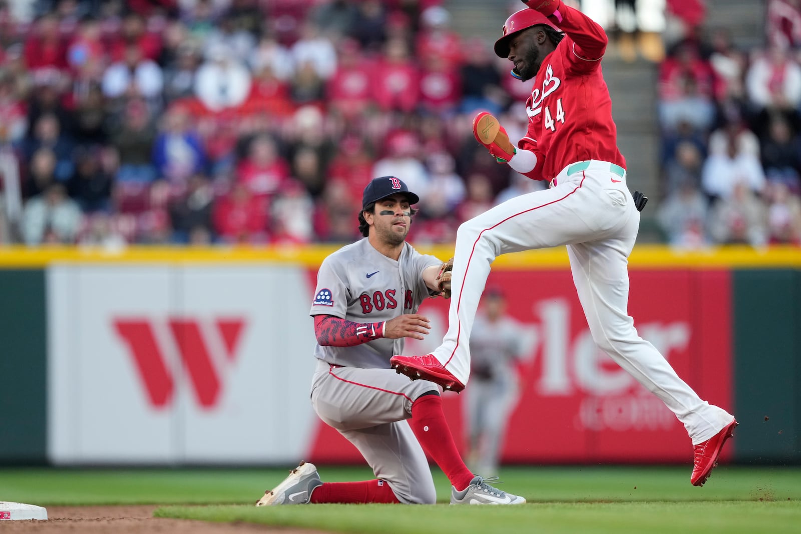 Cincinnati Reds' Elly de la Cruz (44) is tagged out by Boston Red Sox second baseman Marcelo Mayer (11) during the eighth inning of a baseball game in Cincinnati, Saturday, March 28, 2026. (AP Photo/Carolyn Kaster)