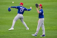 Texas Rangers pitchers Nathan Eovaldi (17) and Jacob Degrom throw in the outfield during a...