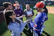Dallas Morning News sportswriter Evan Grant (center) laughs as writers interview Texas...
