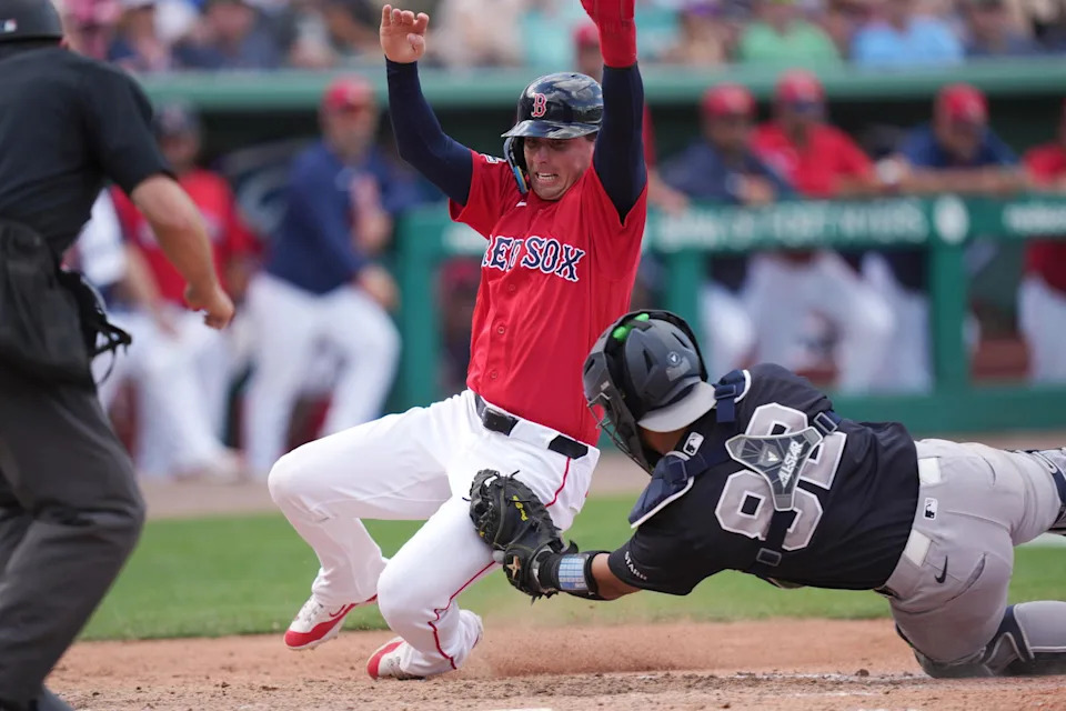Mar 4, 2026; Fort Myers, Florida, USA; Boston Red Sox infielder Nick Sogard (20) is tagged out at the plate by New York Yankees catcher Miguel Palma (82) to complete a double play in the eighth inning at JetBlue Park at Fenway South. (Jim Rassol/Imagn Images)