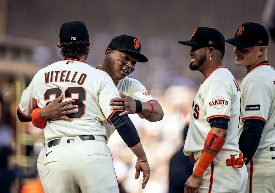 Rafael Devers (16) hugs manager Tony Vitello during introductions before the San Francisco Giants played the New York Yankees in their 2026 Opening Day at Oracle Park in San Francisco, on Wednesday, March 25, 2026. (Carlos Avila Gonzalez/S.F. Chronicle)