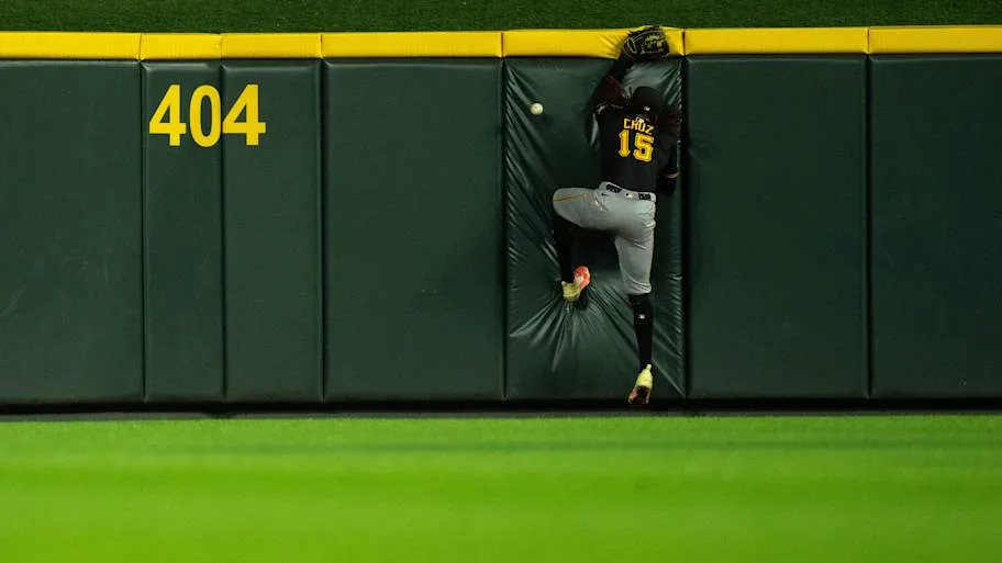 Oneil Cruz hits the wall as Cincinnati Reds right fielder Noelvi Marte scores on an inside the park home run.