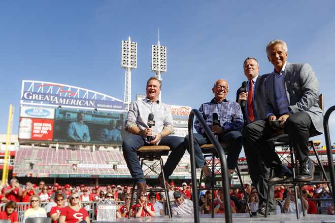 Cincinnati Reds announcer Marty Brennaman, second from left, sits with Jeff Brantley, left, Jim Day, second from right, and Thom Brennaman, right, a farewell event following a baseball game against the Milwaukee Brewers, Thursday, Sept. 26, 2019, in Cincinnati. Brennaman officially retired. (AP Photo/John Minchillo)