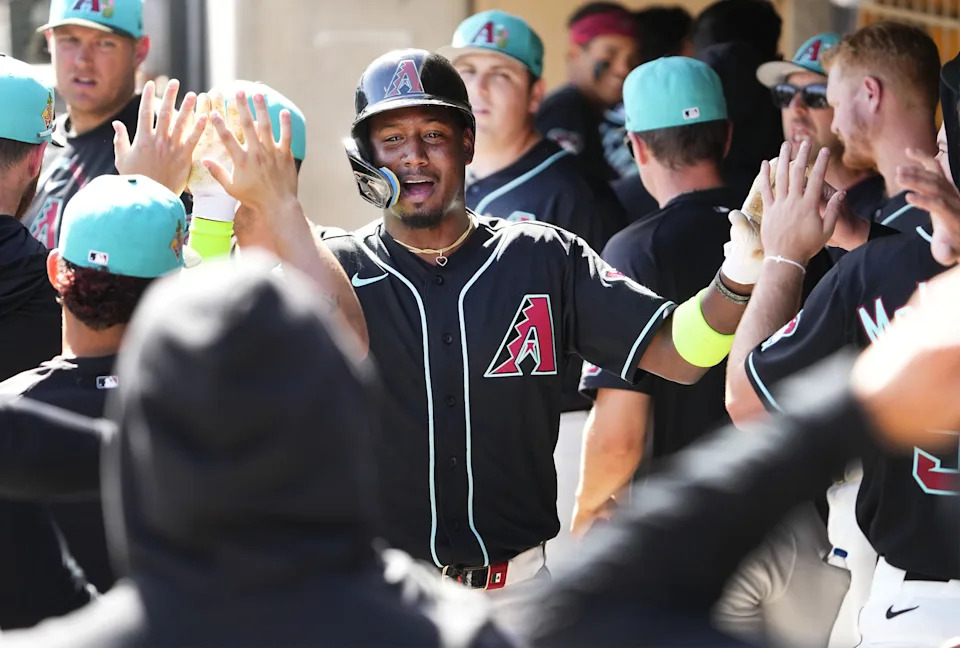 Arizona Diamondbacks shortstop Geraldo Perdomo (2) reacts after scoring on an RBI-double by Nolan Arenado (28) in the first inning on Feb. 25, 2026, at Salt River Fields in Scottsdale.
