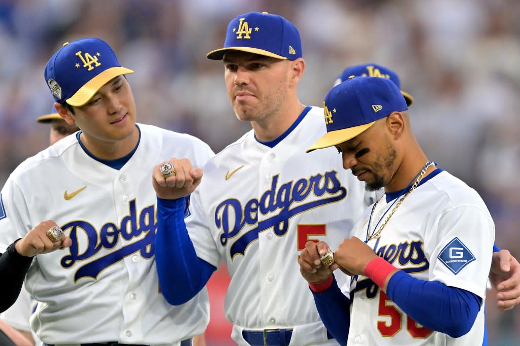 Los Angeles Dodgers two-way player Shohei Ohtani, first baseman Freddie Freeman and shortstop Mookie Betts with their World Series rings during a ceremony prior to the game against the Arizona Diamondbacks at Dodger Stadium. Mandatory Credit: Jayne Kamin-Oncea-Imagn Images IMAGN IMAGES via Reuters Connect