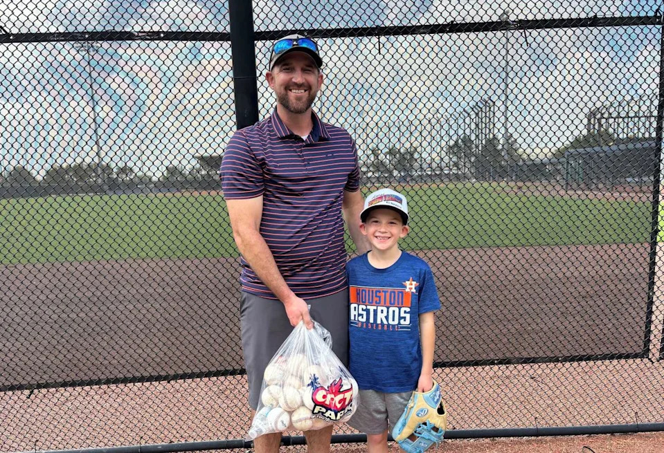 Jake Molling and his 8-year-old son Granger with the bag of home run balls they caught by standing outside the Houston Astros' spring training facility Sunday, March 8, 2026 in West Palm Beach, Florida. (Matt Young/Houston Chronicle)