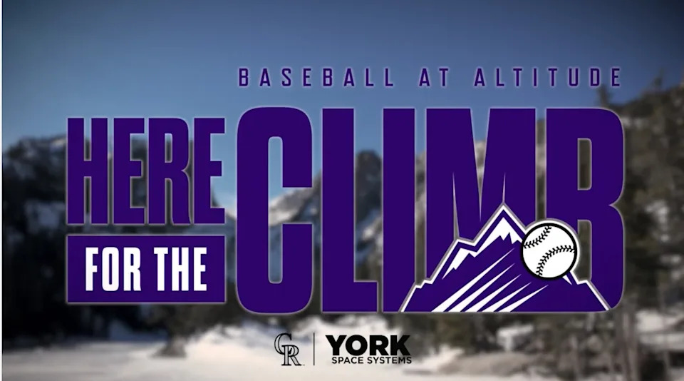A screenshot from the Colorado Rockies media campaign. Snow and mountains are in the background and the purple text reads, “Here for the Climb” with the Rockies logo.