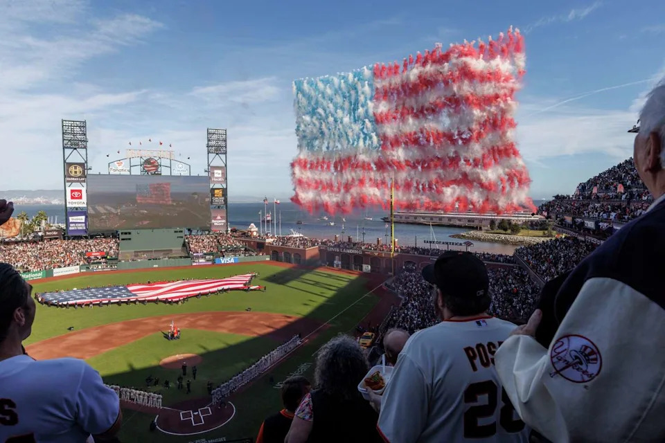 Drones release smoke to create the U.S. flag during the playing of the national anthem for the MLB Opening Night game between the San Francisco Giants and the New York Yankees at Oracle Park in San Francisco, Wednesday, March 25, 2026. (Santiago Mejia/S.F. Chronicle)